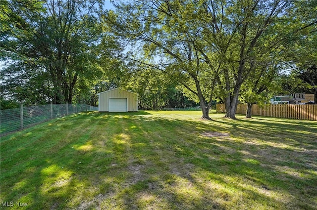 view of yard with an outdoor structure and a garage