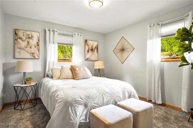 bedroom featuring dark carpet