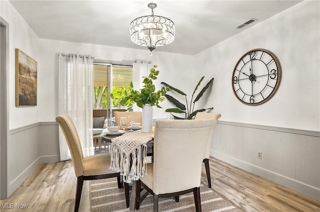 dining room with an inviting chandelier and light hardwood / wood-style floors