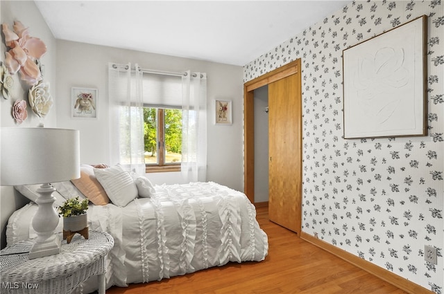 bedroom with hardwood / wood-style flooring