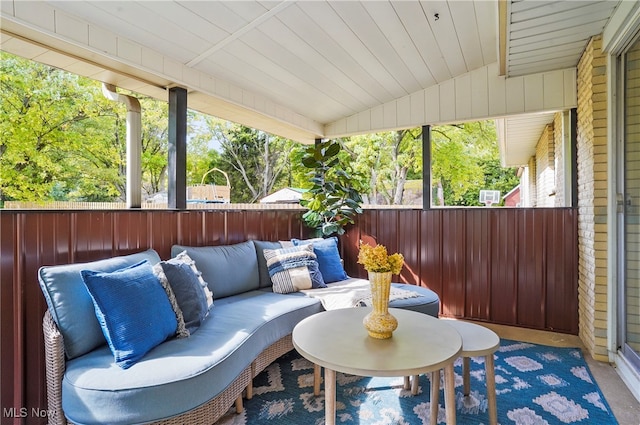 sunroom with wood ceiling and lofted ceiling