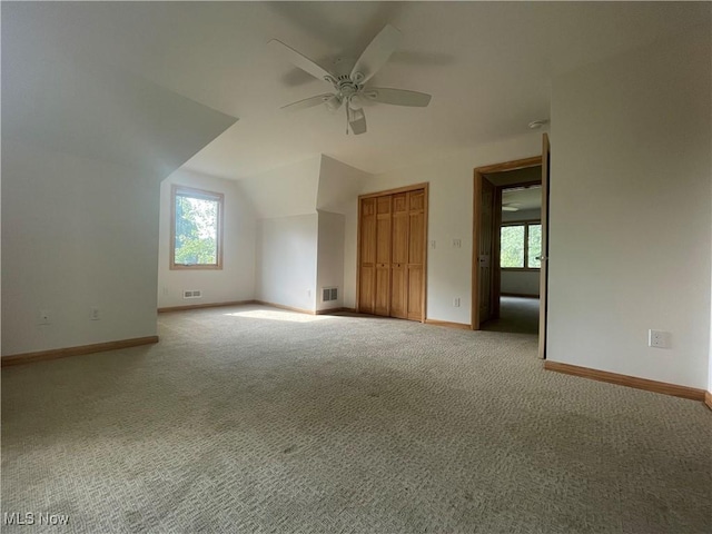 bonus room featuring ceiling fan, vaulted ceiling, and carpet flooring