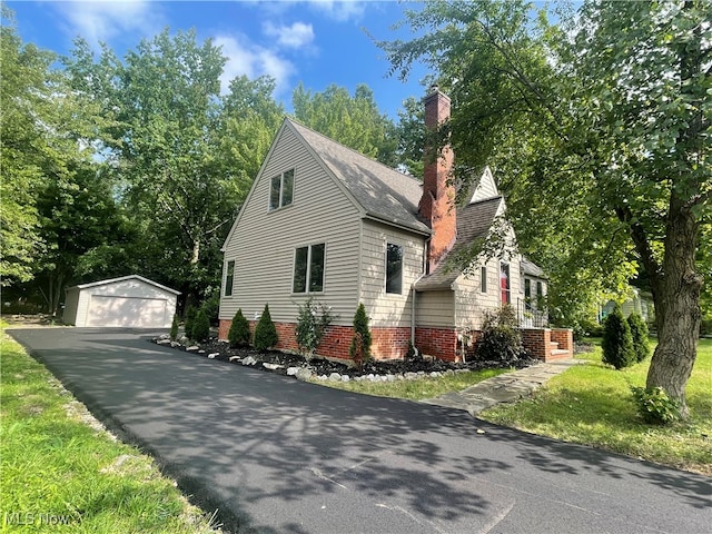 view of side of property featuring a garage and an outdoor structure