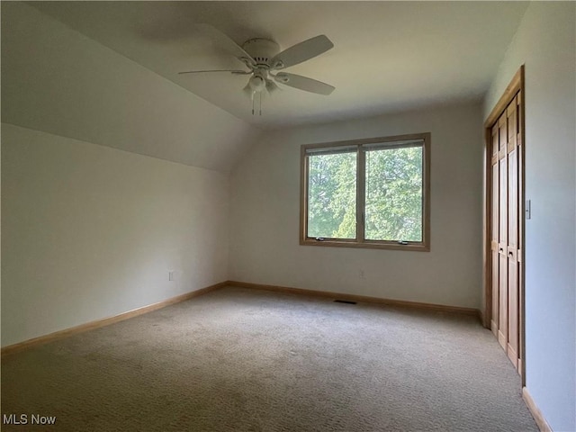 bonus room with ceiling fan, light colored carpet, and vaulted ceiling