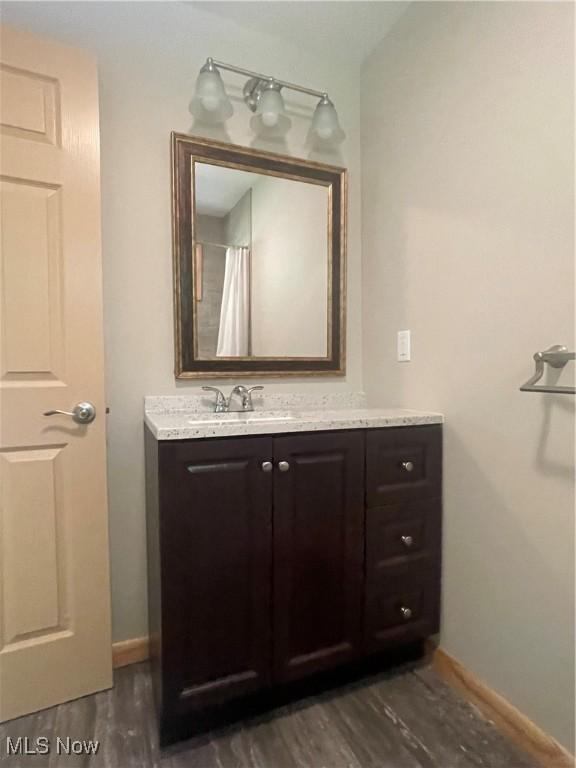 bathroom with vanity and hardwood / wood-style floors