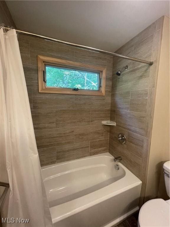 bathroom featuring toilet and shower / bathtub combination with curtain