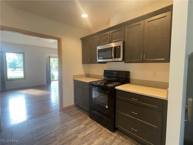 kitchen with hardwood / wood-style floors and black / electric stove