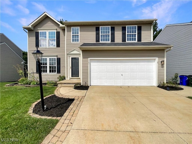 traditional-style house with an attached garage, driveway, and a front lawn