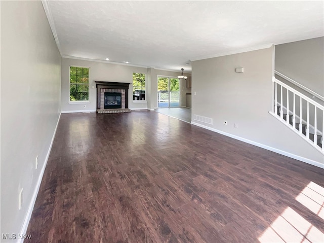 unfurnished living room featuring a fireplace, ornamental molding, and hardwood / wood-style flooring