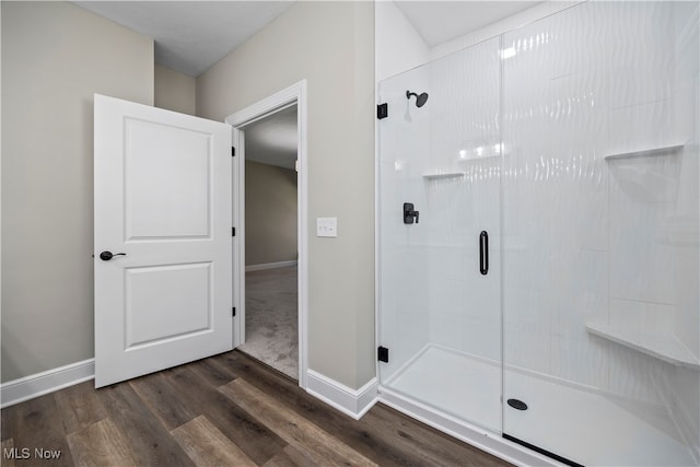 bathroom featuring an enclosed shower and hardwood / wood-style floors