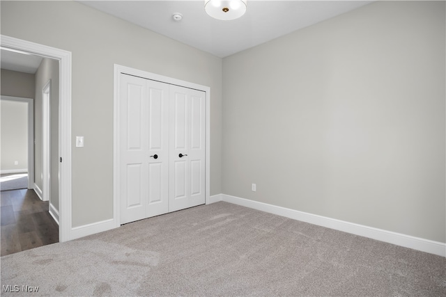 unfurnished bedroom featuring a closet and carpet floors