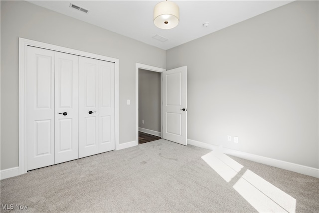 unfurnished bedroom with carpet floors and a closet