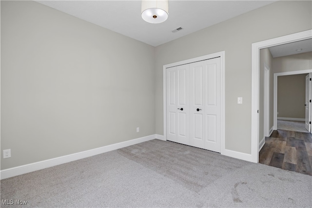 unfurnished bedroom featuring a closet and wood-type flooring