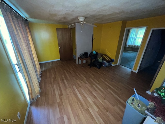 unfurnished living room featuring light wood-type flooring and ceiling fan