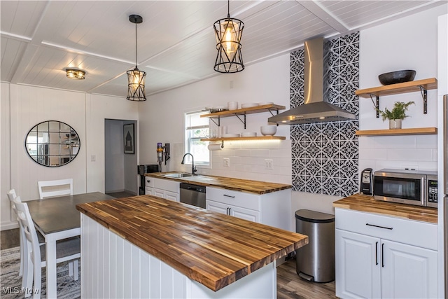 kitchen featuring wood counters, white cabinets, wall chimney exhaust hood, and stainless steel appliances