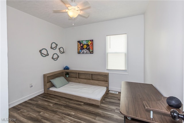 bedroom featuring ceiling fan and dark wood-type flooring