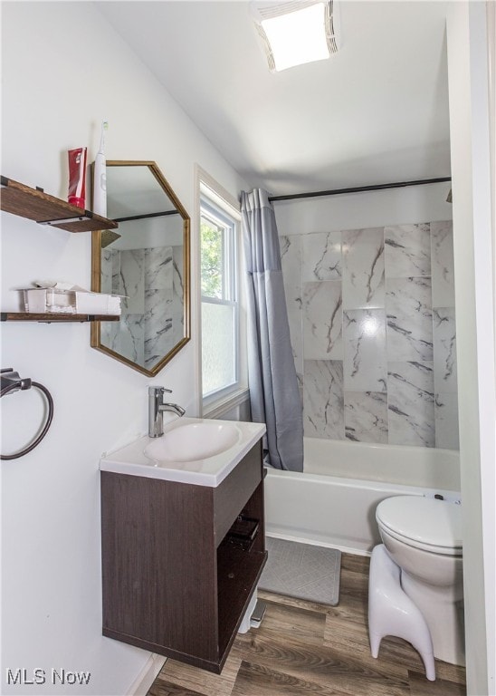 full bathroom with hardwood / wood-style floors, shower / bath combo, toilet, and vanity