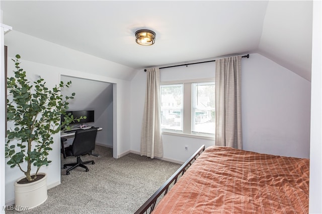 bedroom featuring lofted ceiling and carpet