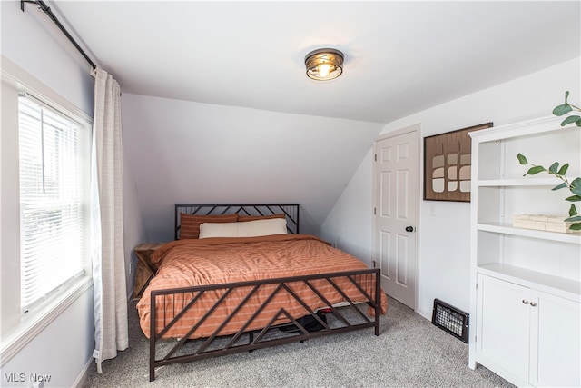 carpeted bedroom with vaulted ceiling