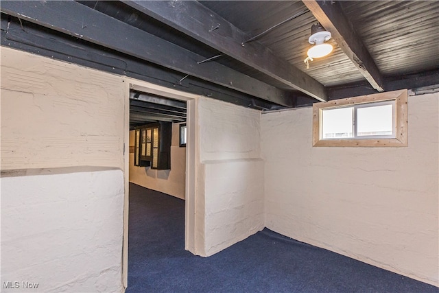 basement featuring carpet flooring and wooden ceiling