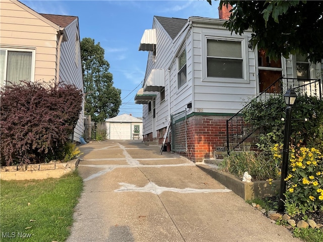 view of side of property featuring a garage and an outbuilding