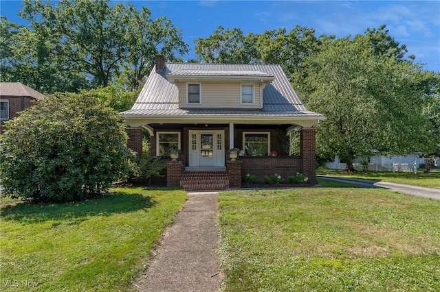 view of front facade with a front yard and covered porch