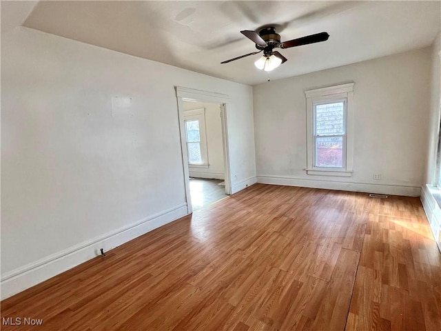 spare room featuring ceiling fan and light hardwood / wood-style floors