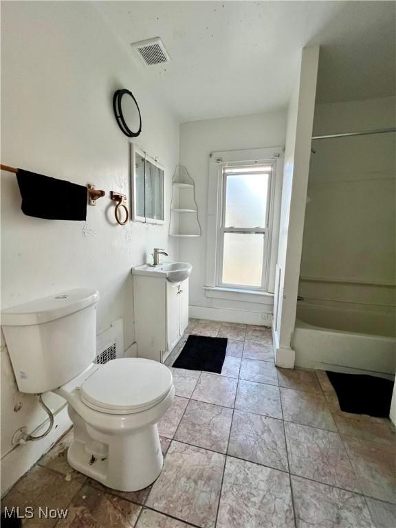 full bathroom featuring vanity, tub / shower combination, and toilet