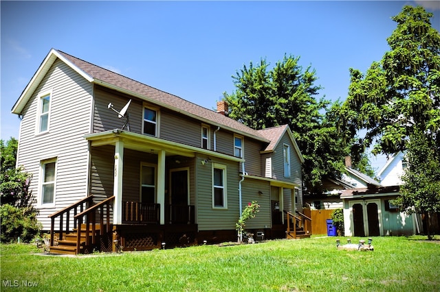 back of house featuring a lawn