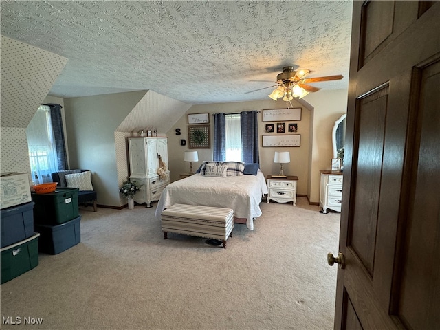 bedroom featuring vaulted ceiling, a textured ceiling, ceiling fan, and carpet floors