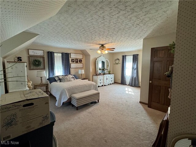 carpeted bedroom with a textured ceiling and ceiling fan