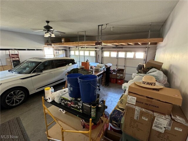 garage featuring ceiling fan and a garage door opener