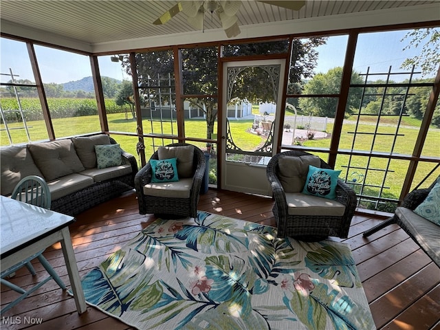 sunroom with ceiling fan and plenty of natural light