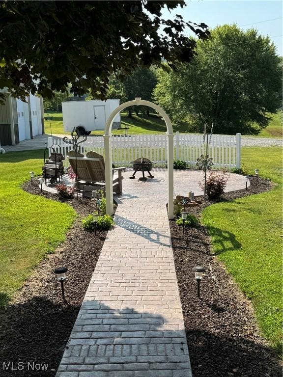 surrounding community featuring a lawn and a patio