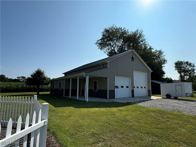 view of home's exterior featuring a garage and a lawn