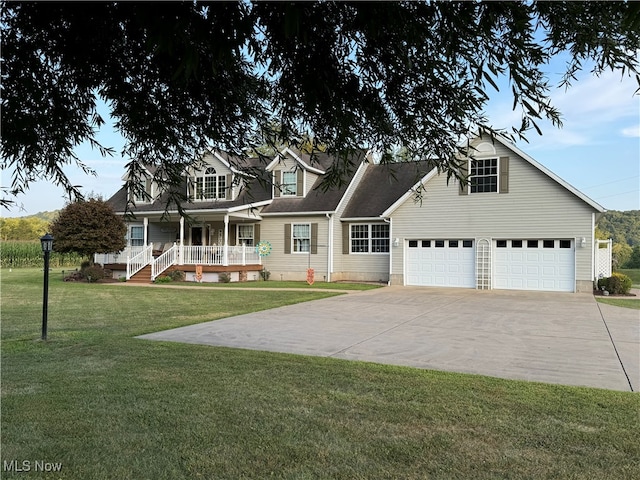 view of front of property featuring a garage, a front lawn, and covered porch