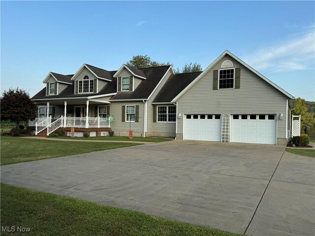 cape cod house with a front yard, a garage, and a porch