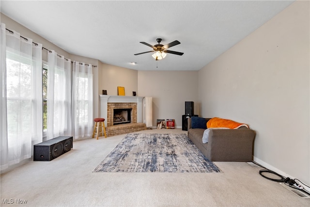 living room with ceiling fan, a fireplace, and carpet floors