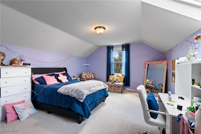 carpeted bedroom with vaulted ceiling and a textured ceiling