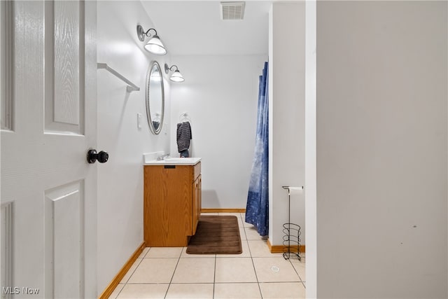 bathroom with tile patterned flooring and vanity