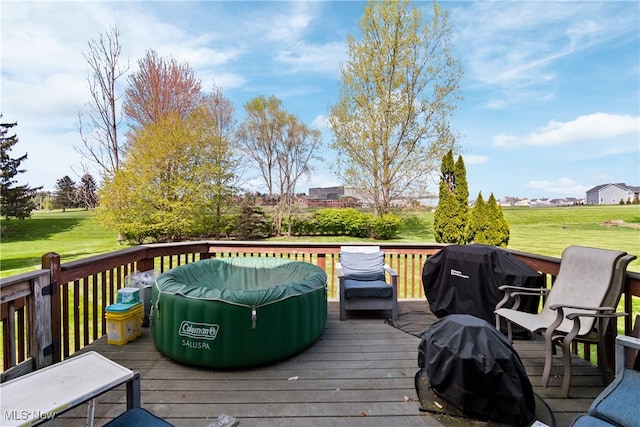 deck with a yard and area for grilling