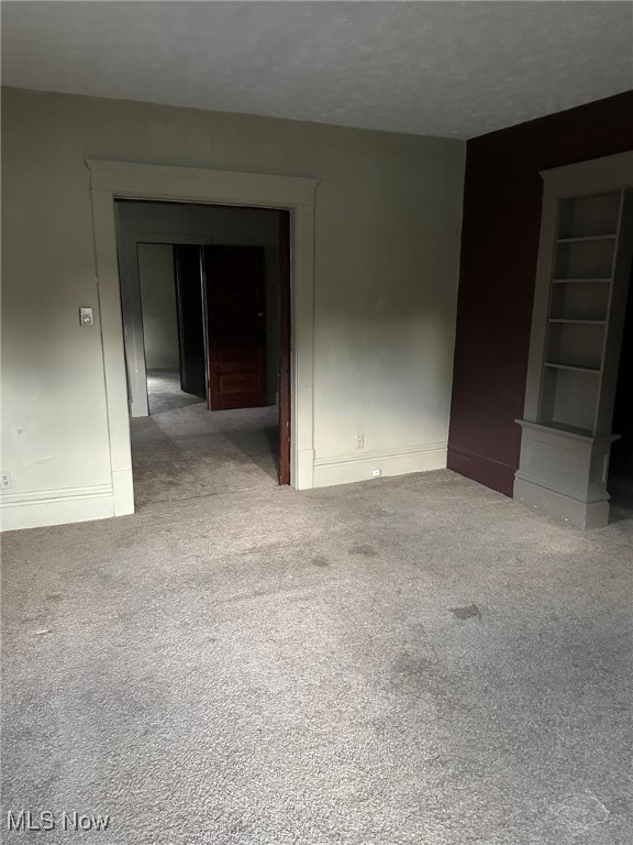 carpeted spare room with built in features