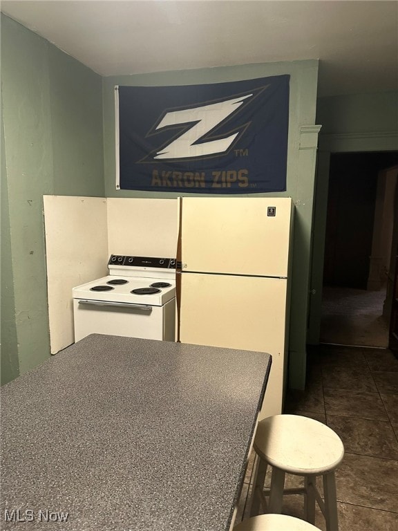 kitchen with white appliances and tile patterned floors