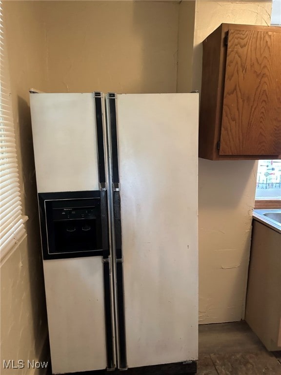 kitchen featuring fridge with ice dispenser