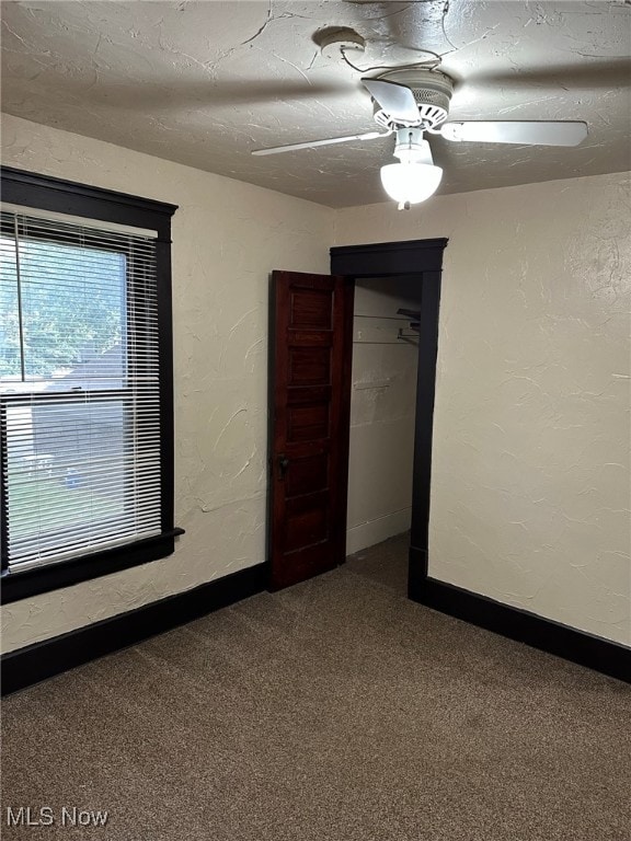 empty room featuring ceiling fan and carpet floors