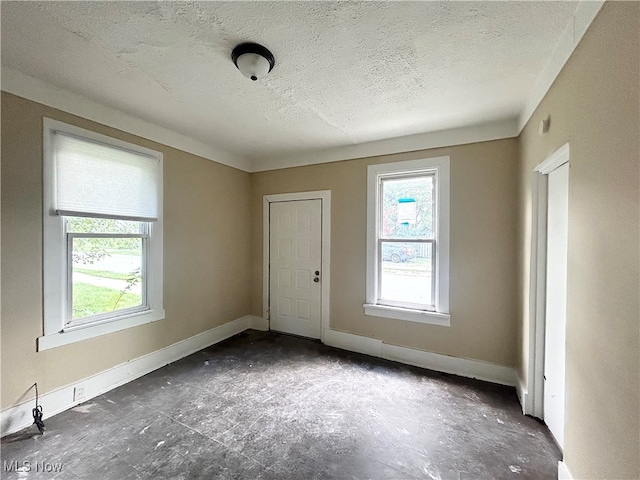 spare room with a textured ceiling