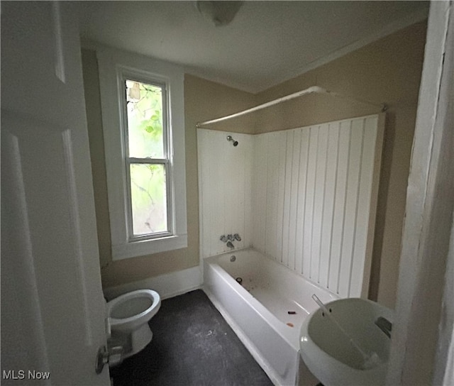 bathroom featuring toilet, plenty of natural light, and bathtub / shower combination