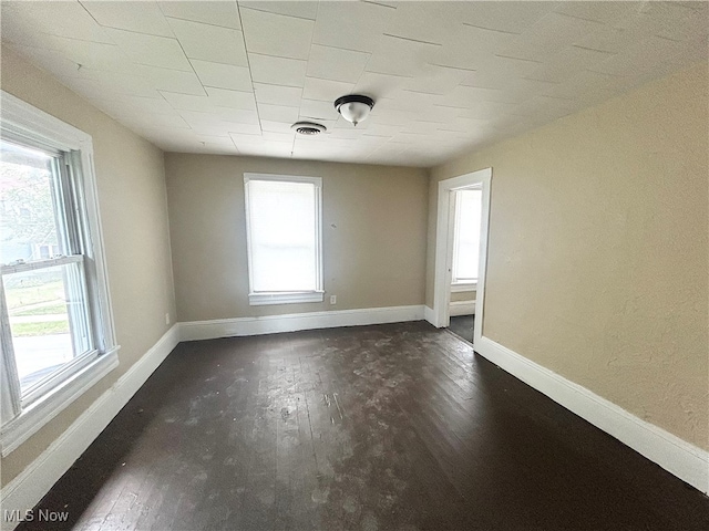 unfurnished room with dark hardwood / wood-style floors