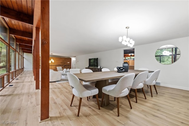 dining room with beam ceiling, a notable chandelier, light hardwood / wood-style flooring, and wood ceiling