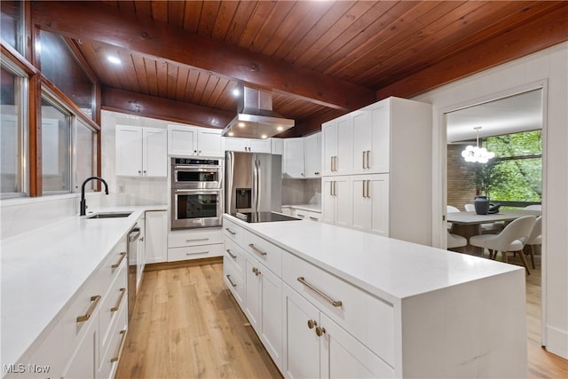 kitchen with beamed ceiling, appliances with stainless steel finishes, wooden ceiling, and light hardwood / wood-style floors